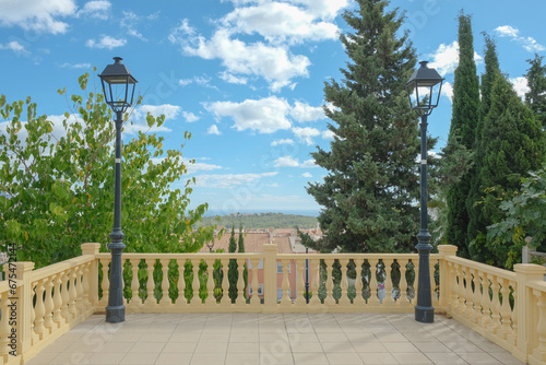 Picturesque location of La Nucia town with house facades, Mediterranean Sea, mountains and blue sky. La Nucia is town and municipality located in Alicante province, Valencian Community of Spain