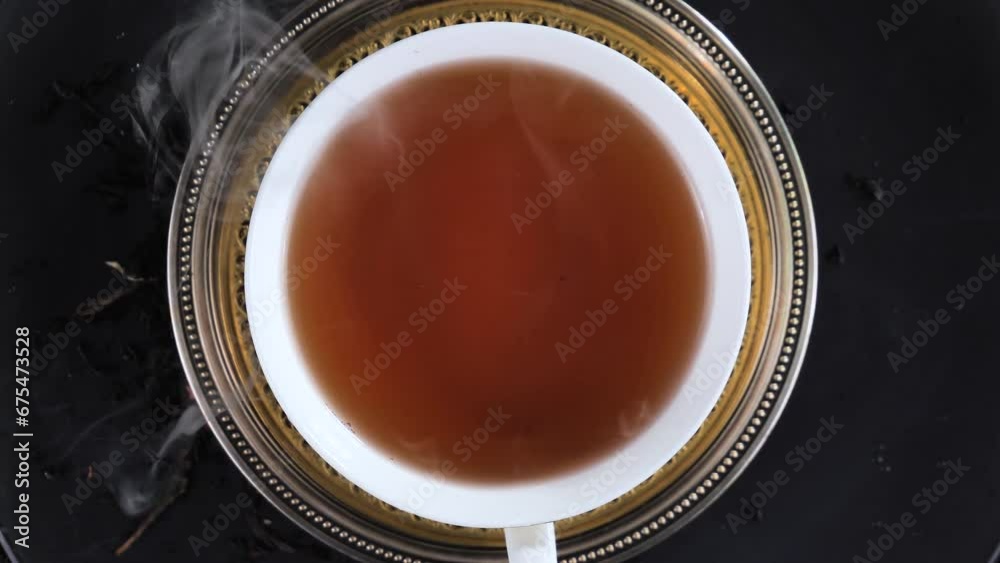 Hot sweet tea in a cup on old background