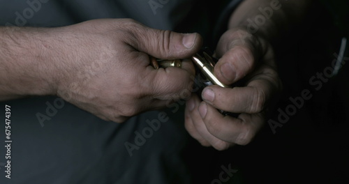 Close-up hand Reloading ammunition. Bullets into clip