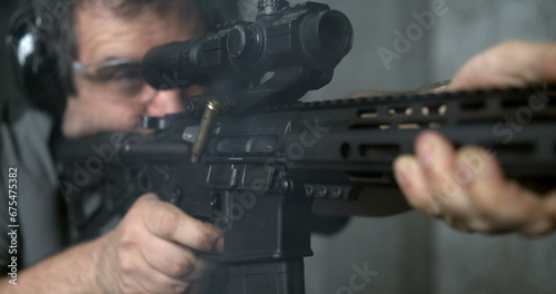 Firing an Assault rifle in super slow-motion 800 fps. Person shooting with AR-15 detail close-up of gun
