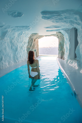 Woman is at Cave style pool with sea view