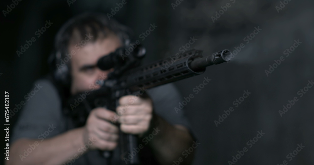 Man aiming an assult rigle and firing bullet in high-speed slow-motion 800 fps Man aiming an assult rigle and firing bullet in high-speed slow-motion 800 fps