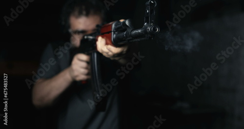 Man aiming with Kalashnikov Weapon firing in super slow-motion at high-speed 800 fps, AK-47 Rifle front view
