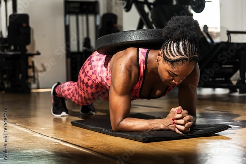a young woman is performing a pushup while working on her hands photo
