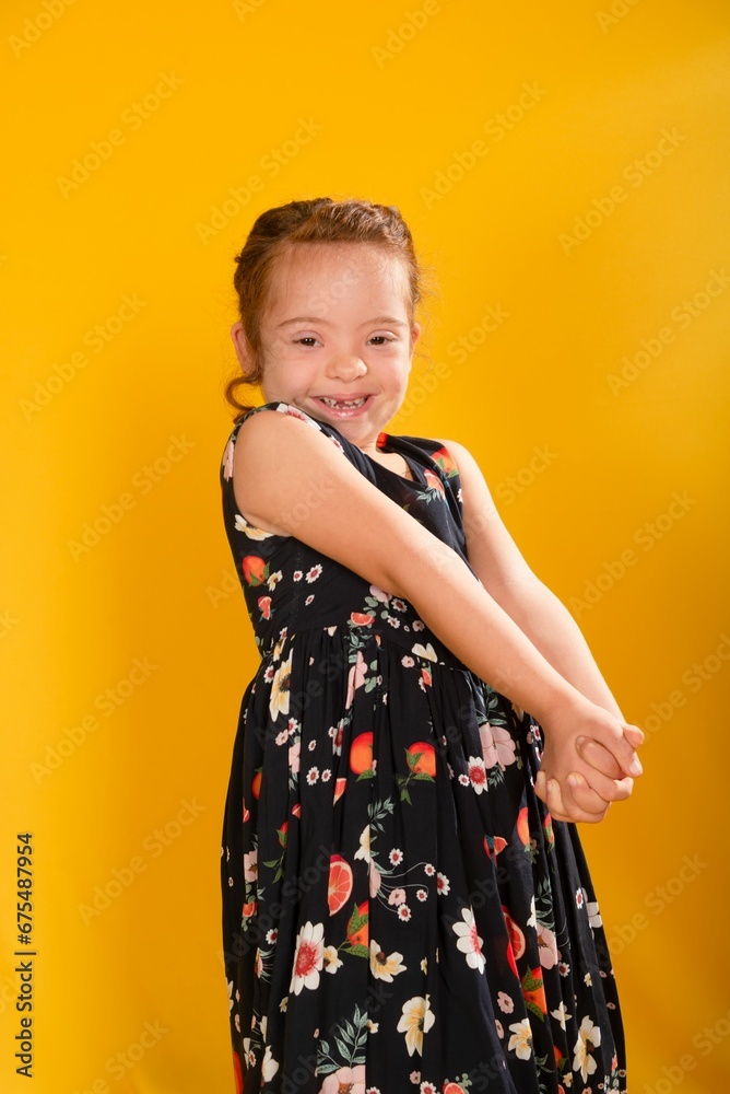 Adorable young girl wearing a stylish black dress smiling brightly Adorable young girl wearing a stylish black dress smiling brightly
