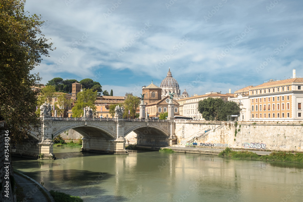 Fototapeta premium Roman cityscape with the Tiber, the bridge Ponte Vittorio Emanuele II and the dome of Saint Peter's Basilica, Rome, Italy