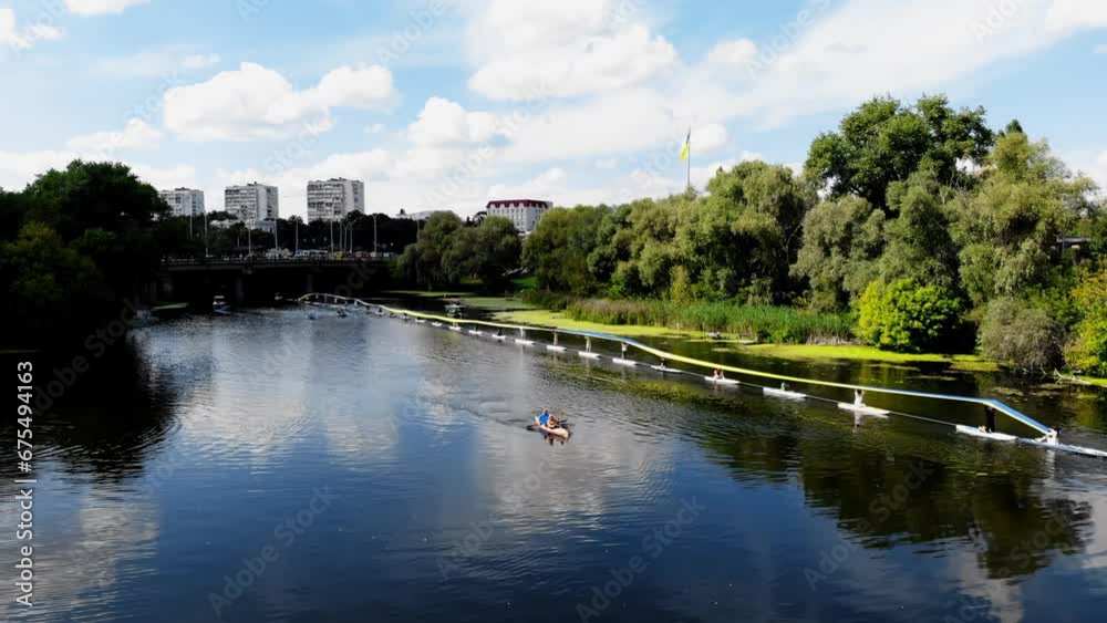 Drone view of people on paddleboards holding a huge Ukrainian flag on the water. The largest flag of Ukraine on the water in Sumy. Many people are sailing on SUP boards and holding the flag of Ukraine Drone view of people on paddleboards holding a huge Ukrainian flag on the water. The largest flag of Ukraine on the water in Sumy. Many people are sailing on SUP boards and holding the flag of Ukraine
