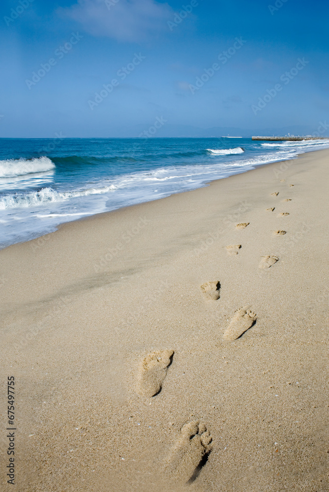 Footprints in the sand with Pacific Ocean Footprints in the sand with Pacific Ocean