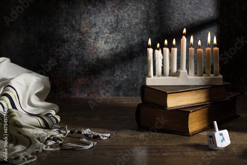 Jewish religious holiday Hanukkah with holiday Hanukkah, dreidel and Taillight on a dark background photo