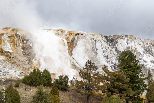 Mammoth hot springs in Yellowstone national park, image shows the steaming cliff coated in sulphur 