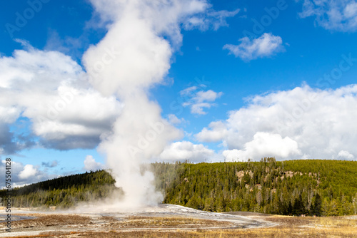 Old faithful geyser erupting shooting hot steam up to 145 feet in the air, Eruptions usually take place every 60 to 90 minutes, October 2023