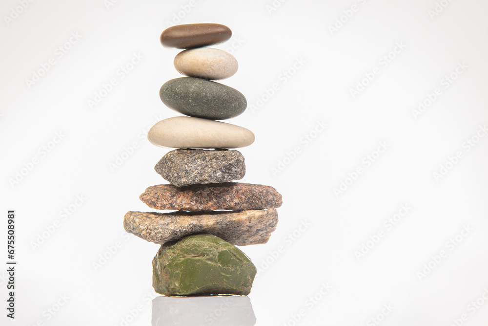 pyramid of stacked stones on a white background. stabilization and balance in life pyramid of stacked stones on a white background. stabilization and balance in life