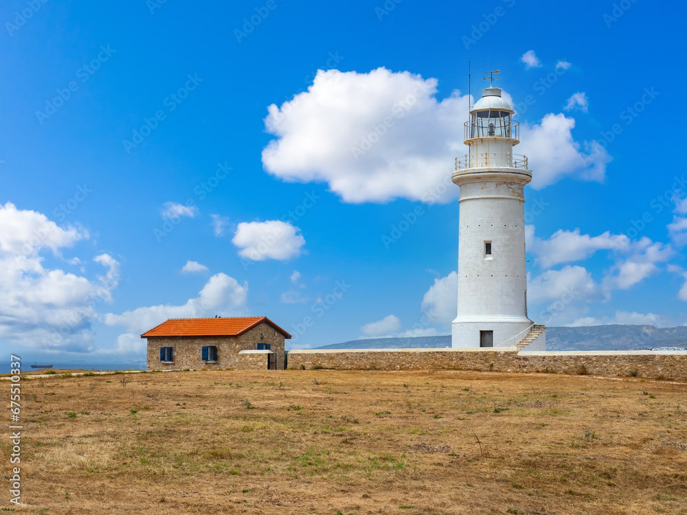 Republic of Cyprus. City of Paphos. White lighthouse near ocean. Cyprus on sunny day. British lighthouse in Cyprus. Landmark of city of Paphos. Lighthouse in archaeological park. Holidays in Paphos