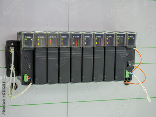 Programmable logic controller. Industrial electrical equipment. Logic controller with leds. Electrical appliance hangs on wall. Programmable controller for production automation. Power tech photo