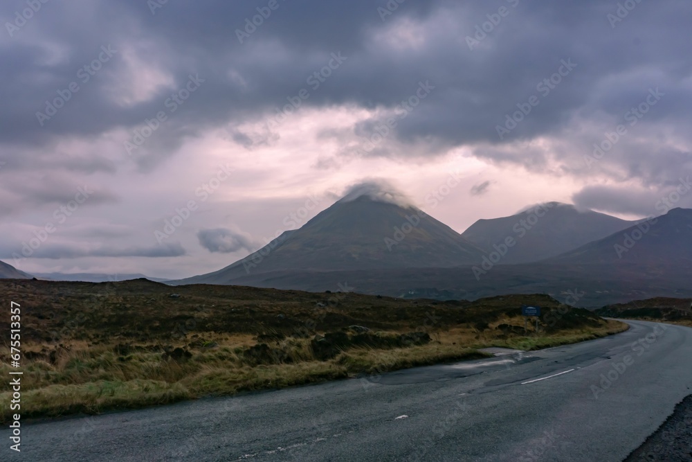 Scenic view of a long, deserted road running through a vast, verdant landscape Scenic view of a long, deserted road running through a vast, verdant landscape