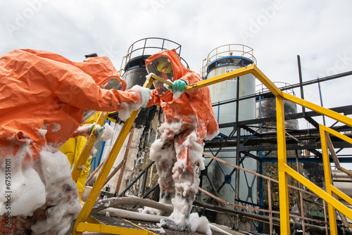 Photos Firefighters in protective chemical suits respond to an explosion and fire of fl