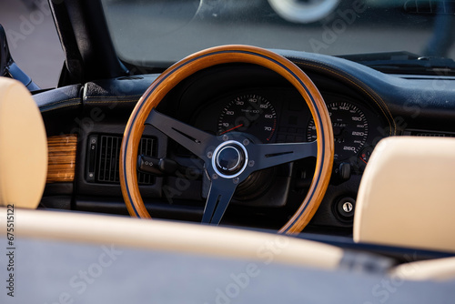 wooden steering wheel in car. Car interior with dashboard, speedometer and tachometer © Konstantin