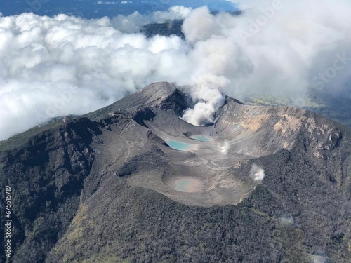 View of an active volcano with billowing clouds in the background