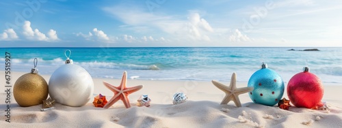 Christmas ball, starfish, decorations on white sand and sea background. New Yeaar, Xmas holiday vacation in exotic countries, tropics concept, Copy space for text