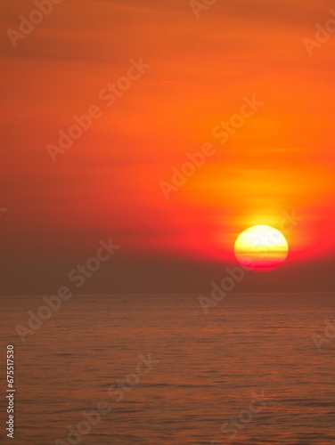 Vertical shot of a majestic breathtaking sunset over the sea in the evening