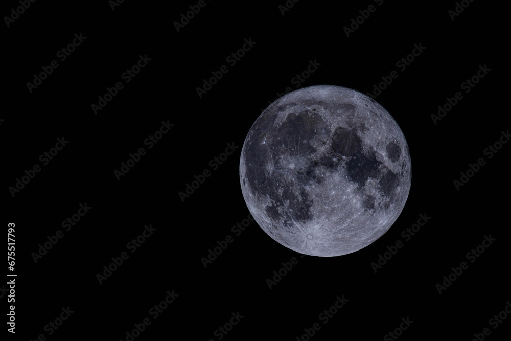 Fototapeta premium Breathtaking image of a full moon shining in the night sky - perfect for wallpapers