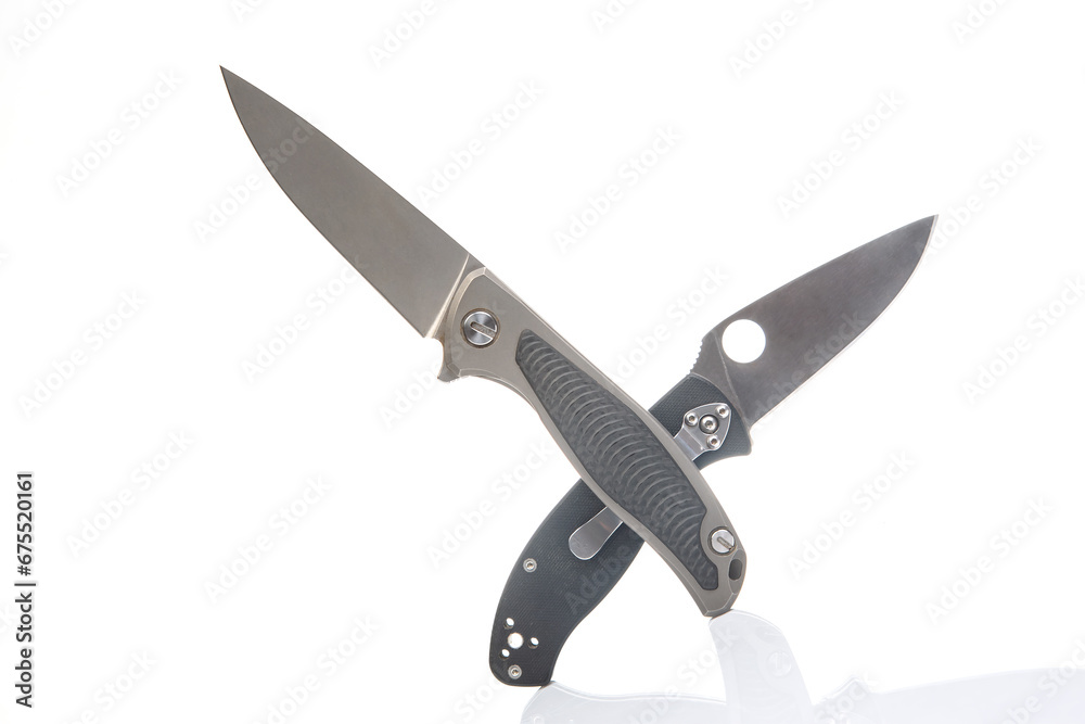 two folding knives on a white background. item for tourism and survival. two folding knives on a white background. item for tourism and survival.