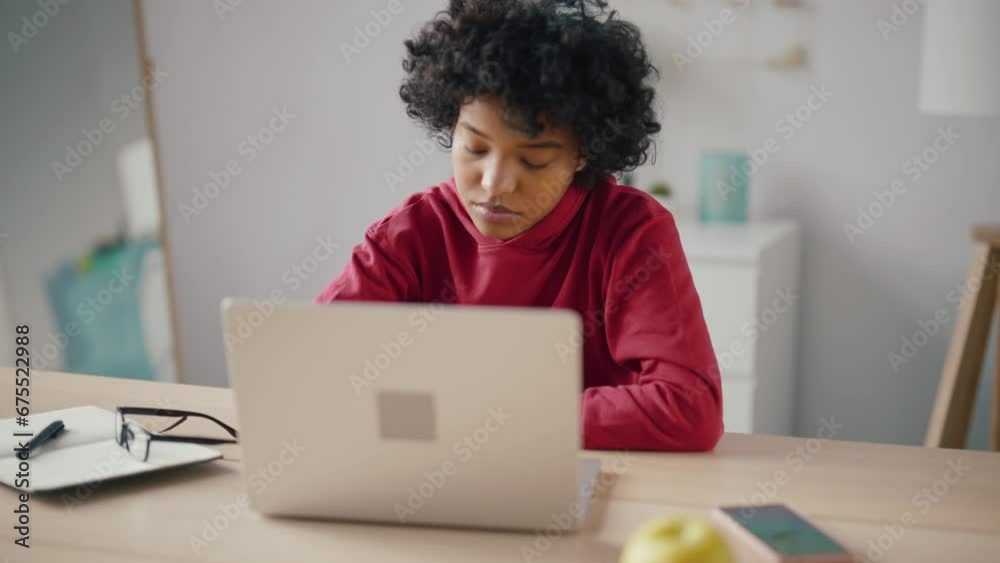 African american woman freelancer having online meeting on laptop sitting at table on workplace at home office. Female talking with clients colleagues discussing project. Online distant remote work. African american woman freelancer having online meeting on laptop sitting at table on workplace at home office. Female talking with clients colleagues discussing project. Online distant remote work.