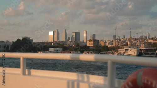 deck and railings from cruise ship, yacht or boat. Beautiful sunset and ocean view, Bosphorus in Turkey on viewf Istanbul with flag. Slow motion shot deck boat moving on calm sea during bright sunset photo