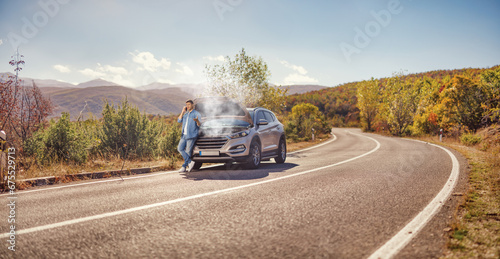 Man with a car breakdown calling a road help service photo