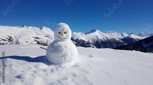 A cheerful snowman with a stunning alpine backdrop on a bright winter day.