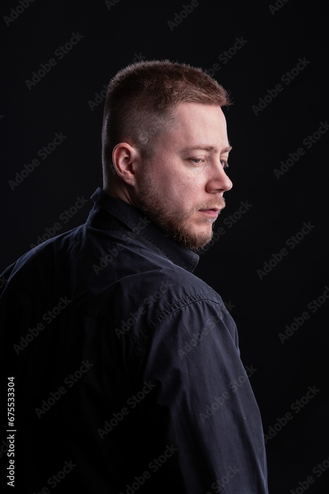Strict and stylish Man in black shirt on dark background. Strict and stylish Man in black shirt on dark background.