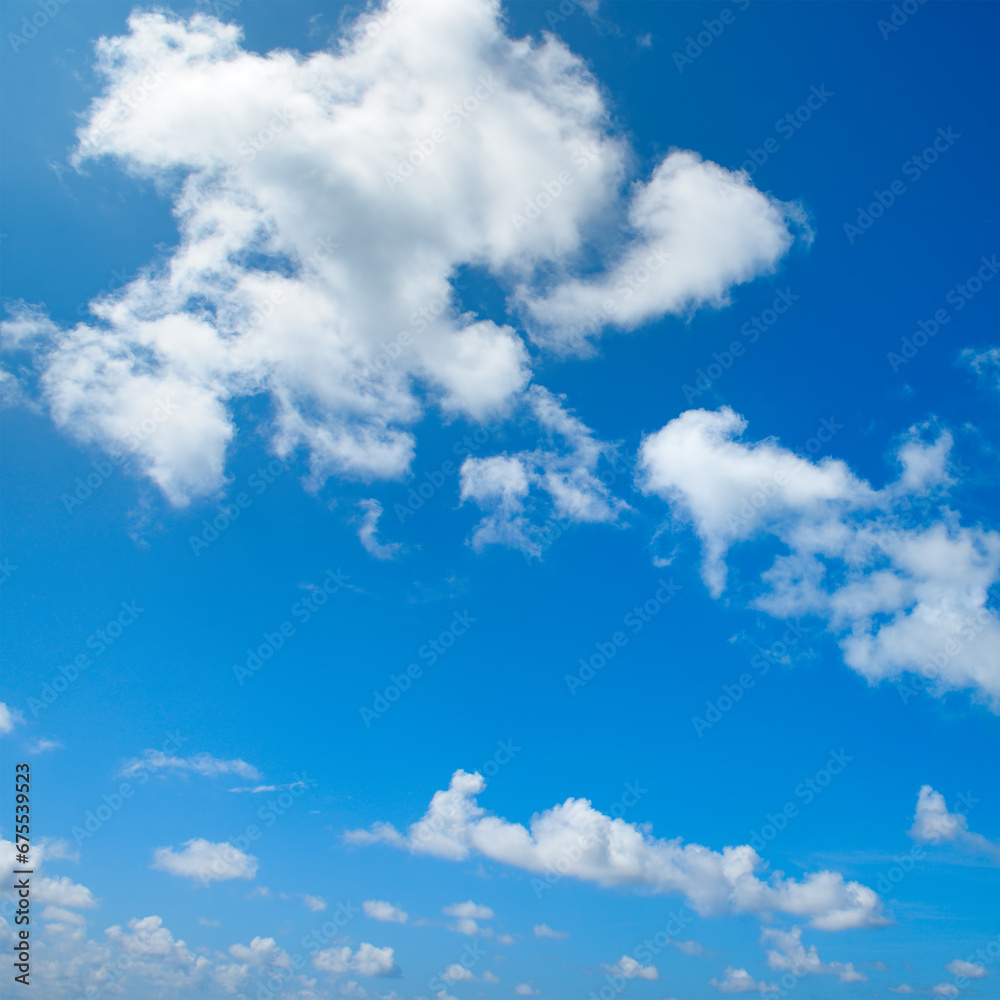 White fluffy clouds and bright sun on blue sky. White fluffy clouds and bright sun on blue sky.