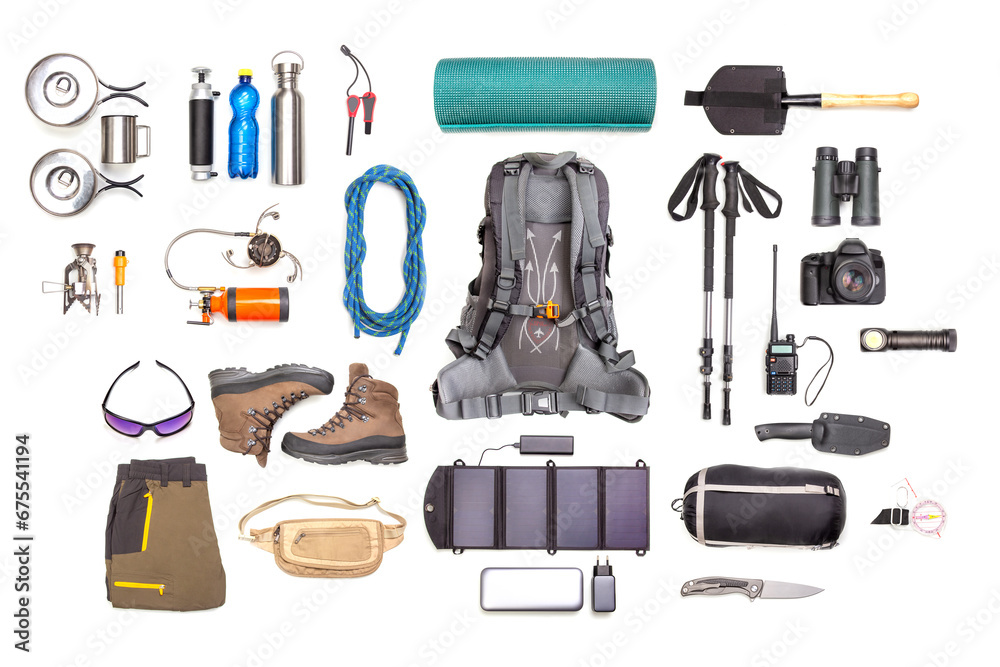 Set of tourist trekking items on white background. Top view of accessories for travel. Equipment for travel and hiking. Survival Items.