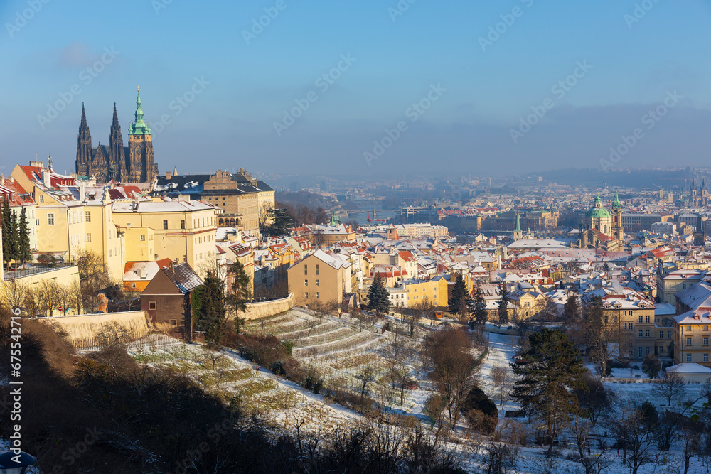 Snowy Prague City with gothic Castle in the sunny Day from the Hill Petrin, Czech republic