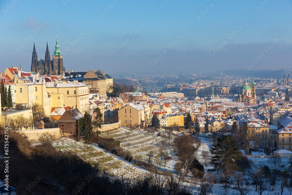 Obraz premium Snowy Prague City with gothic Castle in the sunny Day from the Hill Petrin, Czech republic