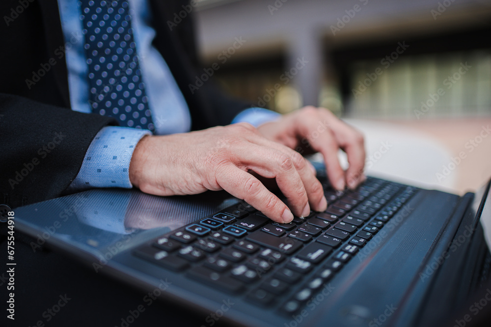 Close up business man hands typing on laptop computer keyboard, online remote working or searching information, sending e-mails or messaging sitting outside. Unrecognizable entrepreneur using internet Close up business man hands typing on laptop computer keyboard, online remote working or searching information, sending e-mails or messaging sitting outside. Unrecognizable entrepreneur using internet