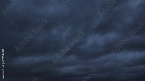 Very black sky with storms moving across the sky photo