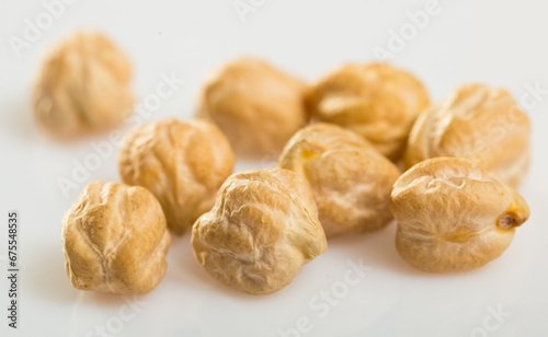 Chickpea seeds closeup on white surface. Organic food for healthy eating..
