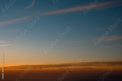 Amazing aerial view on mountain peaks during sunset. High mountain landscape in winter.
