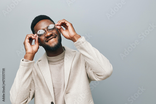 Cheerful african man wearing glasses jean jacket having white snow smile pointing fingers aside at copy space for your text advertisement, advertise teeth whitening or eyewear store good offer concept