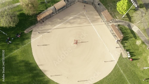 Aerial Drone view of kids play Baseball Field at Park on Sunny Day photo