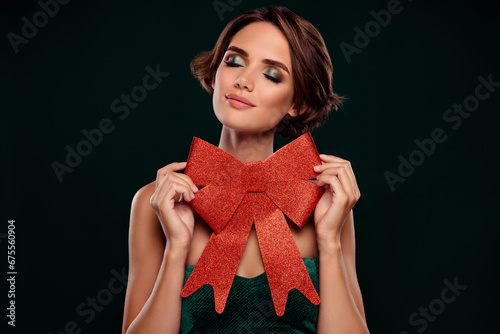 Photo of pretty girl celebrate christmas on vip cocktail party enjoy gift red ribbon over dark background © Beauty Hero