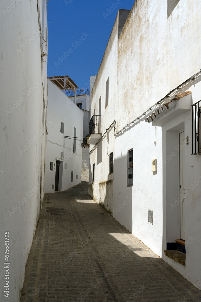 Beautiful street in the historical center of the white beautiful village of Vejer de la Frontera in a sunny day, Cadiz province, Andalusia, Spain