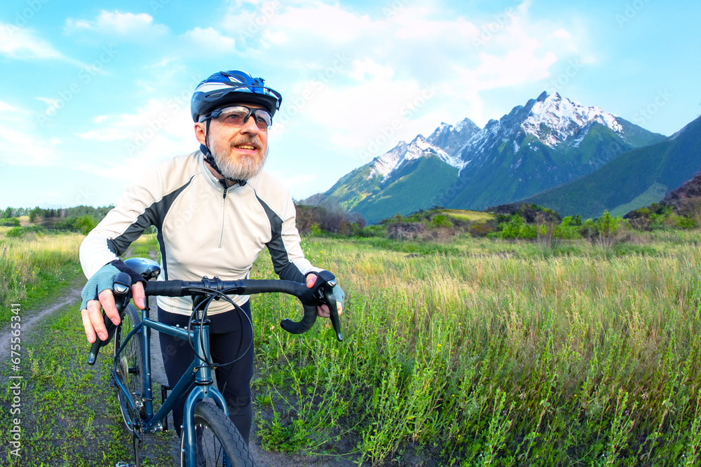 Fototapeta premium bearded man cyclist rides a bike on a road in nature. sports, hobbies and entertainment for health