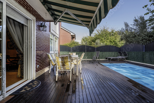 Canvastavla Terrace with covered pool of a single-family home with acacia wood floors, an ou