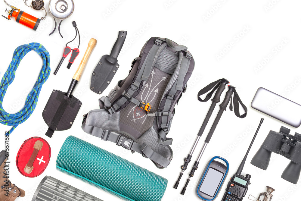 Set of tourist trekking items on white background. Top view of accessories for travel. Equipment for travel and hiking. Survival Items.