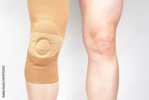 bandage for fixing the injured knee of the human leg on a white background. medicine and sports. limb injury treatment photo