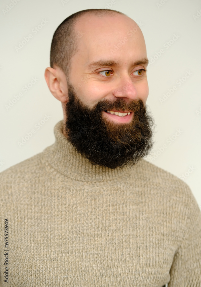 Fototapeta premium close-up male face, young pensive bearded and mustachioed man, satisfied guy with 30 years smiling and looks away, concept of human health, good mood, optimism