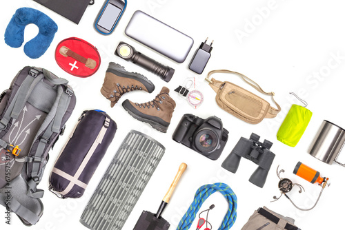 Set of tourist trekking items on white background. Top view of accessories for travel. Equipment for travel and hiking. Survival Items. photo