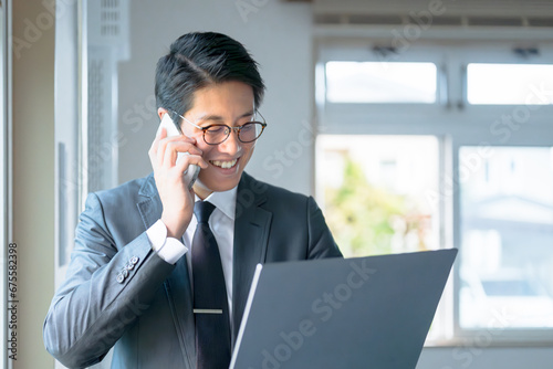PC見ながら電話するビジネスマン photo